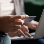 Cặp đôi đang mua sắm trực tuyến an toàn bằng máy tính xách tay và thẻ tín dụng.