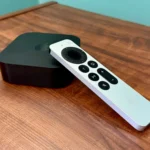 Thiết bị Apple TV 4K và remote điều khiển trên bàn gỗ.